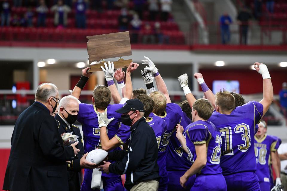 Winner holds their trophy aloft after winning the class 11B state football championship on Friday, November 13, at the DakotaDome in Vermillion.