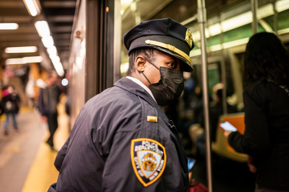 NYPD officers patrol platforms and train cars at the 36th Street subway station where a shooting attack occurred the previous day during the morning commute, Wednesday, April 13, 2022, in New York.  Mayor Eric Adams said Wednesday that officials were now seeking 62-year-old Frank R. James as a suspect.  (AP Photo/John Minchillo) ORG XMIT: NYJM109