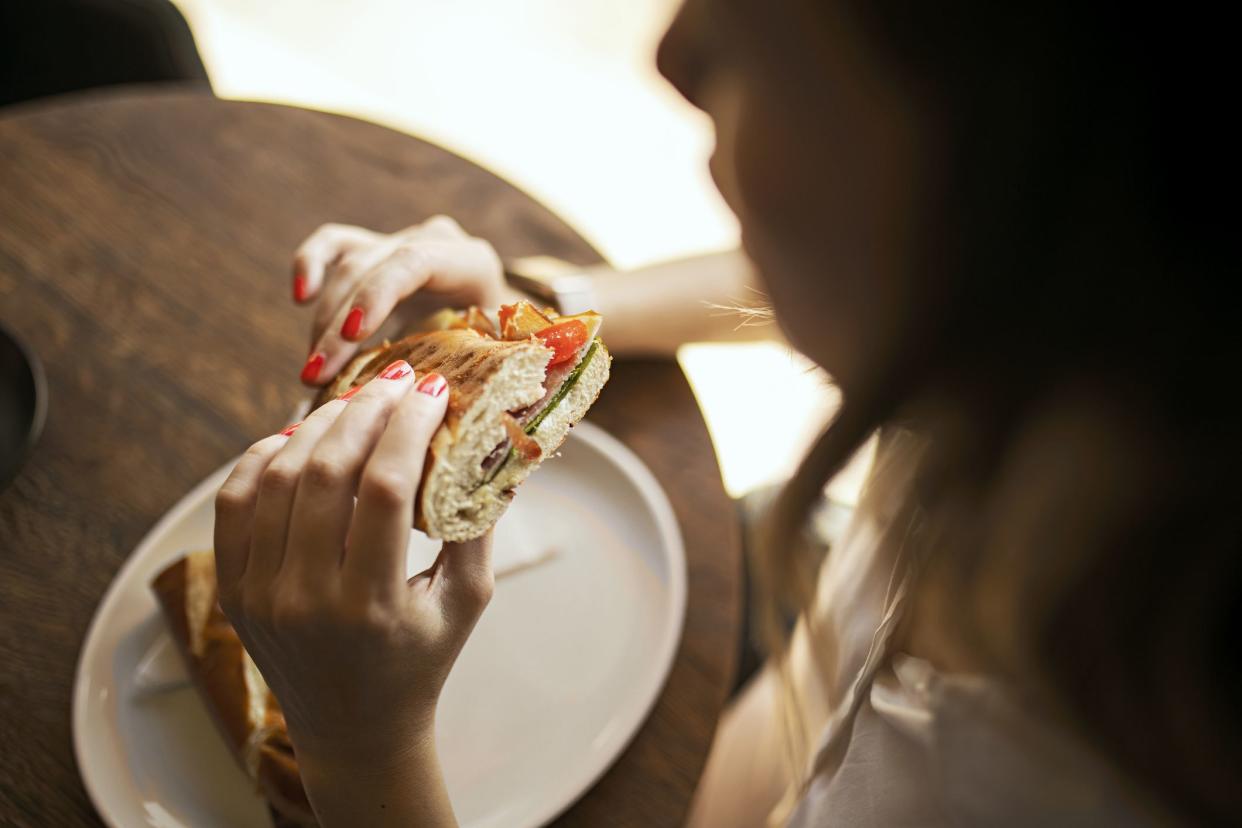 Young woman eating a sandwich