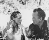 <p>James Bond creator Ian Fleming chats with actress Ursula Andress between scenes of <em>Dr. No.</em></p>