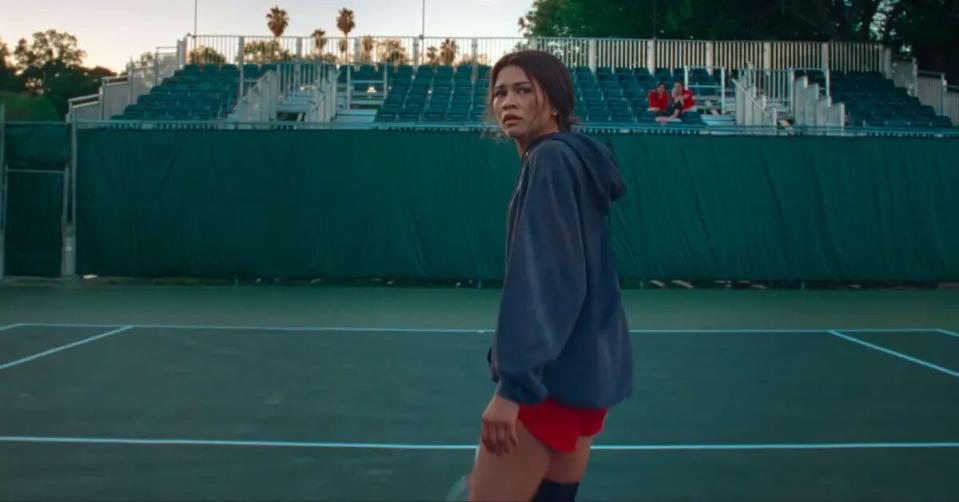 a person standing on a tennis court