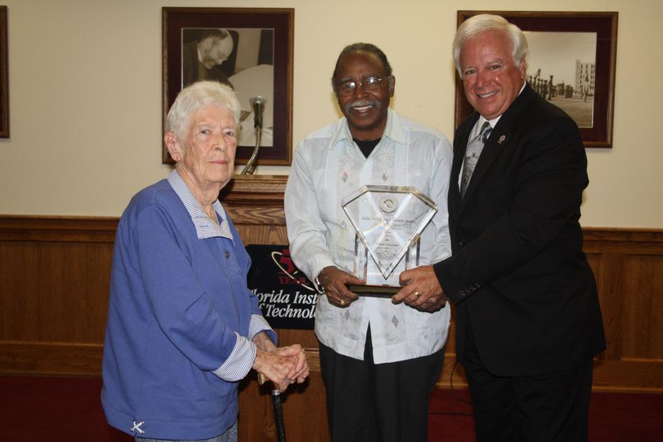 Weona Cleveland (left) stands with Julius Montgomery and Florida Institute of Technology President Anthony Catanese during the 2009 Julius Montgomery Pioneer Award presentation.