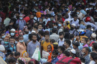 Thousands of people leaving for their native places to celebrate Eid-al-Fitr throng the Mawa ferry terminal ignoring risks of coronavirus infection in Munshiganj, Bangladesh, Thursday, May 13, 2021. (AP Photo/Mahmud Hossain Opu)