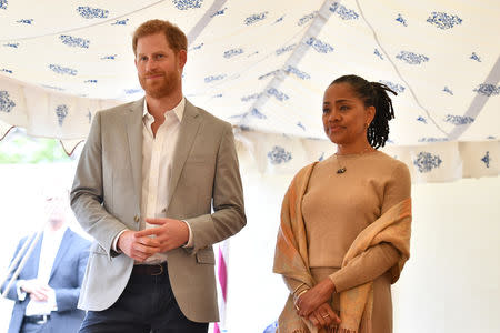 Britain's Prince Harry, and Doria Ragland listen to Meghan, Duchess of Sussex speaking at the launch of a cookbook with recipes from a group of women affected by the Grenfell Tower fire at Kensington Palace in London, Britain September 20, 2018. Ben Stansall/Pool via Reuters