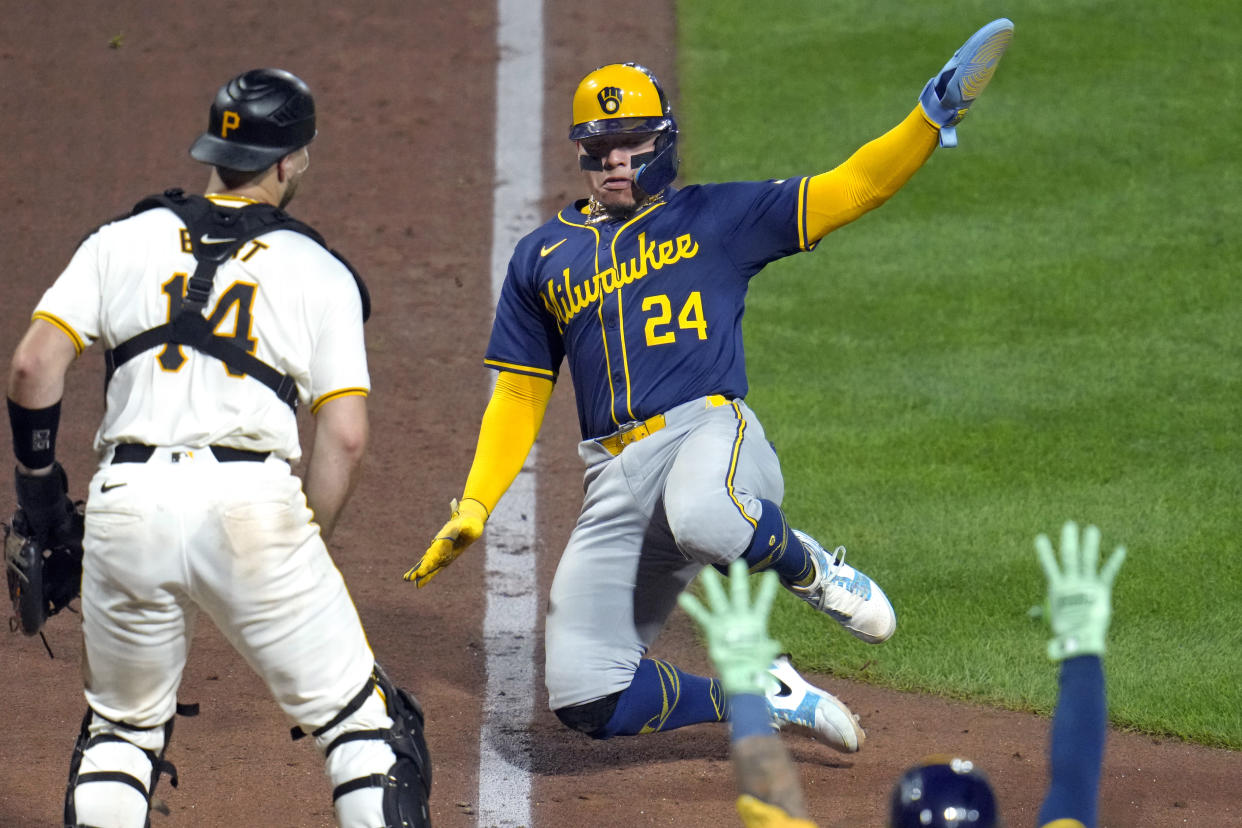 Milwaukee Brewers' William Contreras (24) scores from third on a sacrifice fly by Sal Frelick off Pittsburgh Pirates relief pitcher Joey Wentz during the seventh inning of a baseball game in Pittsburgh, Tuesday, Sept. 24, 2024. (AP Photo/Gene J. Puskar)