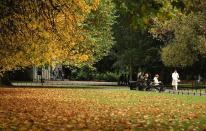 People walk through the autumn leaves in St Stephen's Green in Dublin, Ireland.