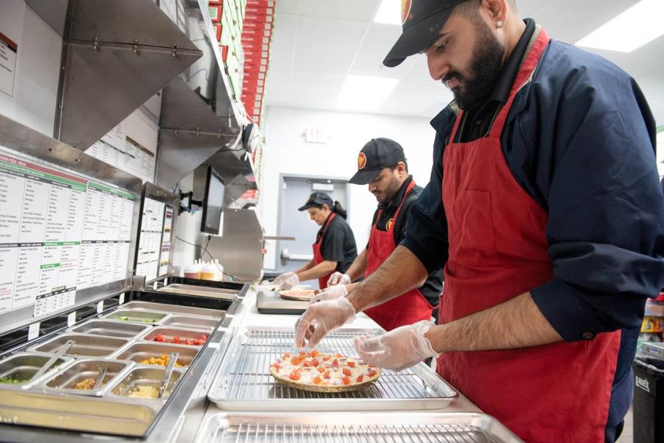 Anmol Sekhon prepares a pizza at Pizza Twist in Modesto, Calif., Thursday, April 6, 2023.