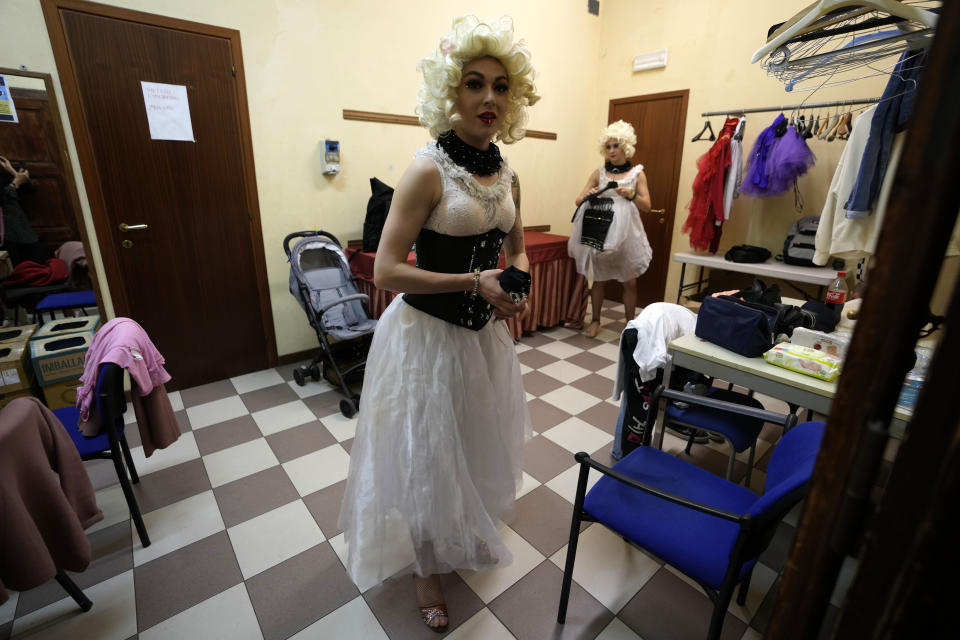 Performer Hanna Honcharenko, walks backstage before the start of the show "Alice in Wonderland" in Pistoia, Italy, Friday, May 6, 2022. A Ukrainian circus troupe is performing a never-ending “Alice in Wonderland” tour of Italy. They are caught in the real-world rabbit hole of having to create joyful performances on stage while their families at home are living through war. The tour of the Theatre Circus Elysium of Kyiv was originally scheduled to end in mid-March. (AP Photo/Alessandra Tarantino)