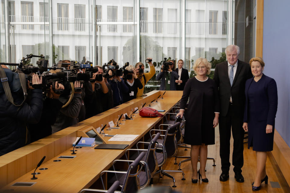 German Interior Minister Horst Seehofer, center, German Justice Minister Christine Lambrecht, left, and German Minister for Family Affairs, Senior Citizens, Women and Youth, Franziska Giffey, right, arrive for a news conference in Berlin, Germany, Wednesday, Oct. 30, 2019 on a package of measures against far-right extremism and anti-Semitism. Chancellor Angela Merkel's Cabinet signed off Wednesday on the tightening of gun laws, stricter persecution of hate crime online, and more financial support for initiatives fighting anti-Semitism and far-right extremism. (AP Photo/Markus Schreiber)