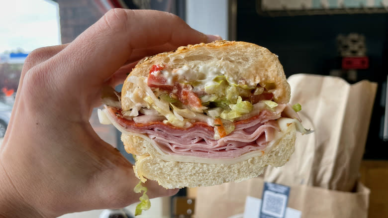Hand holding sandwich
