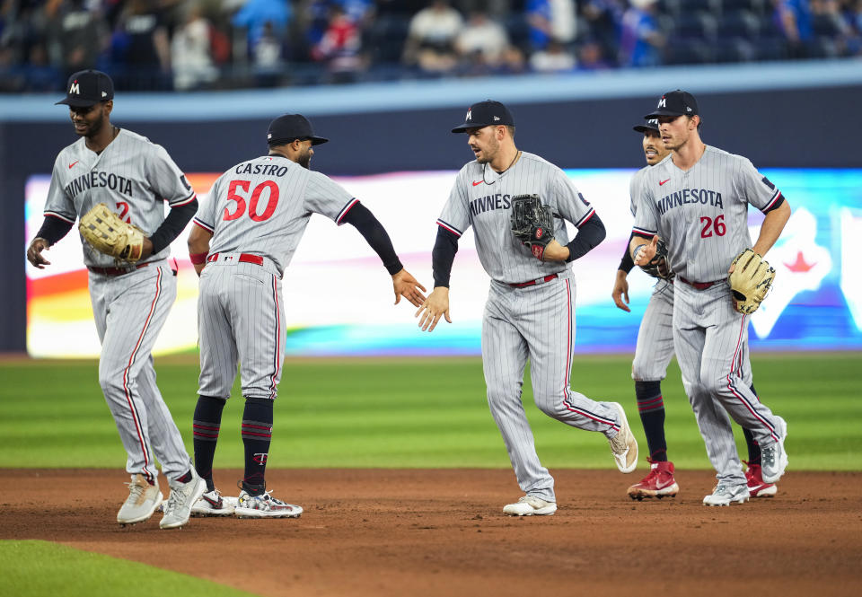 Minnesota Twins' Michael A. Taylor, Willi Castro, Trevor Larnach, Carlos Correa, and Max Kepler, from left, celebrate the team's win over the Toronto Blue Jays in a baseball game Friday, June 9, 2023, in Toronto. (Mark Blinch/The Canadian Press via AP)