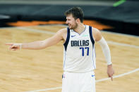 Dallas Mavericks guard Luka Doncic (77) signals to his bench after scoring against the San Antonio Spurs during the second half of an NBA basketball game in San Antonio, Friday, Jan. 22, 2021. (AP Photo/Eric Gay)