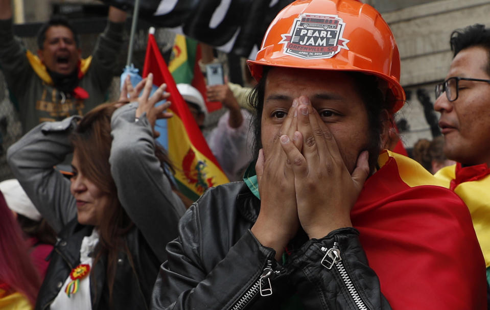 Opponents of Bolivia's President Evo Morales celebrate after he announced his resignation, in La Paz, Bolivia, Sunday, Nov. 10, 2019. Morales resigned Sunday under mounting pressure from the military and the public after his re-election victory triggered weeks of fraud allegations and deadly protests. (AP Photo/Juan Karita)