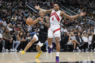 San Antonio Spurs' Jeremy Sochan (10) drives against Toronto Raptors' Scottie Barnes (4) during the first half of an NBA basketball game, Sunday, Nov. 5, 2023, in San Antonio. (AP Photo/Darren Abate)