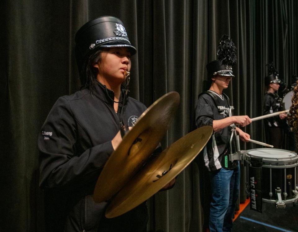 Burncoat High School musicians, including drum major Tiffany Vuong, rehearse before a performance Tuesday at Worcester Technical High School.
