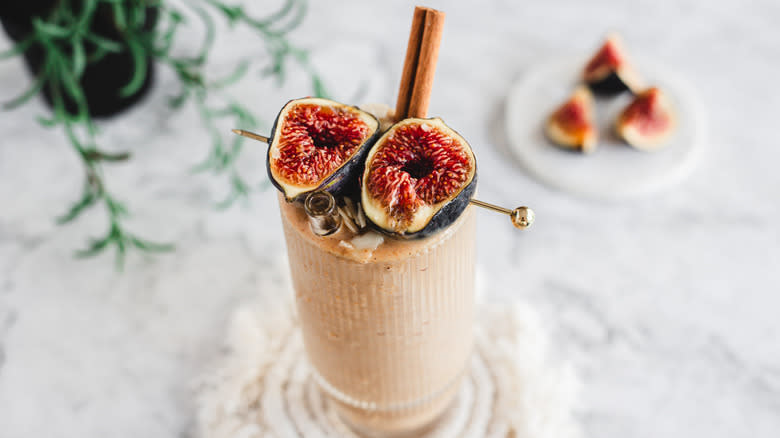 Smoothie with fresh figs in background