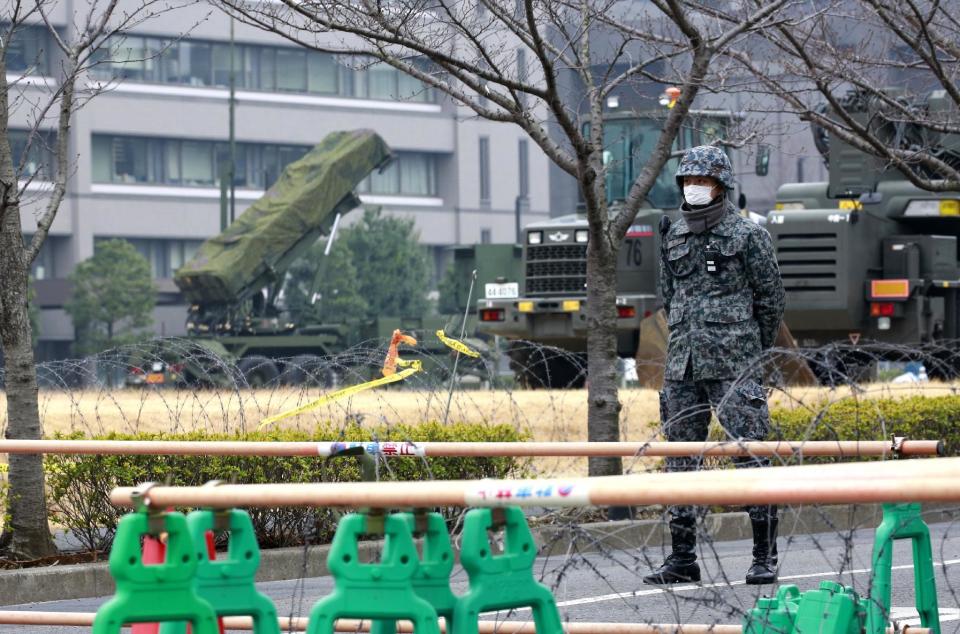 A member of Japan Self-Defense Force stands by a PAC-3 Patriot missile unit deployed against the North Korea's missile firing, at the Defense Ministry in Tokyo, Monday, March 6, 2017. North Korea on Monday fired four banned ballistic missiles that flew about 1,000 kilometers (620 miles), with three of them landing in Japan's exclusive economic zone, South Korean and Japanese officials said, in an apparent reaction to huge military drills by Washington and Seoul that Pyongyang insists are an invasion rehearsal. (AP Photo/Shizuo Kambayashi)