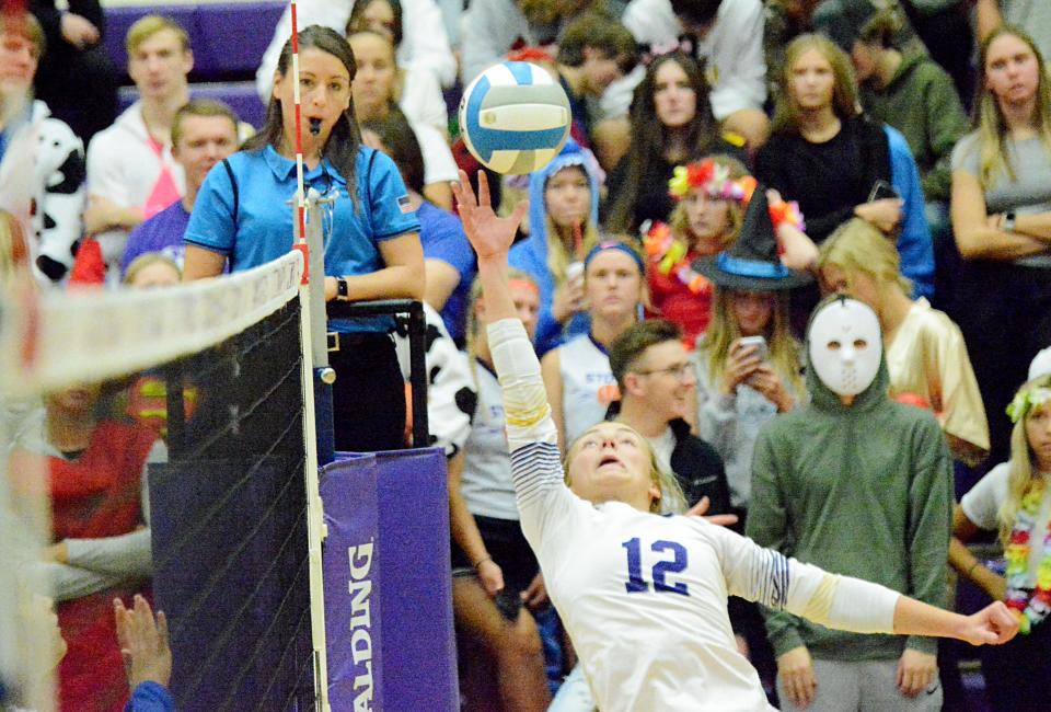 With Watertown High School fans in Halloween costumes looking on, Watertown's Miranda Falconer attempts to keep the ball alive during an Eastern South Dakota Conference volleyball match against Aberdeen Central on Tuesday, Oct. 25, 2022 in the Watertown Civic Arena. Aberdeen Central won 3-1.