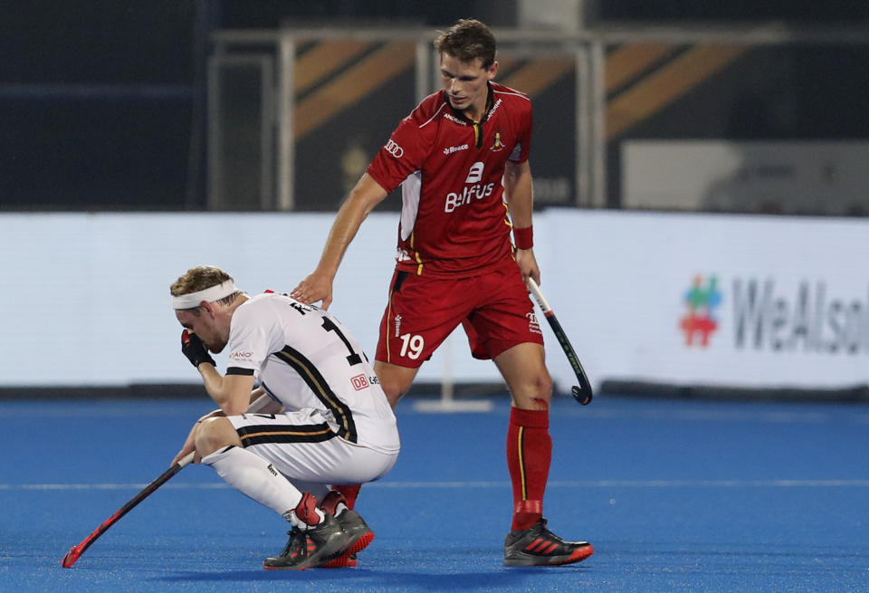 Germany's Timm Herzbruch, left, reacts after their loss during the Men's Hockey World Cup quarterfinal match between Belgium and Germany at the Kalinga Stadium in Bhubaneswar, India, Thursday, Dec. 13, 2018. (AP Photo/Aijaz Rahi)