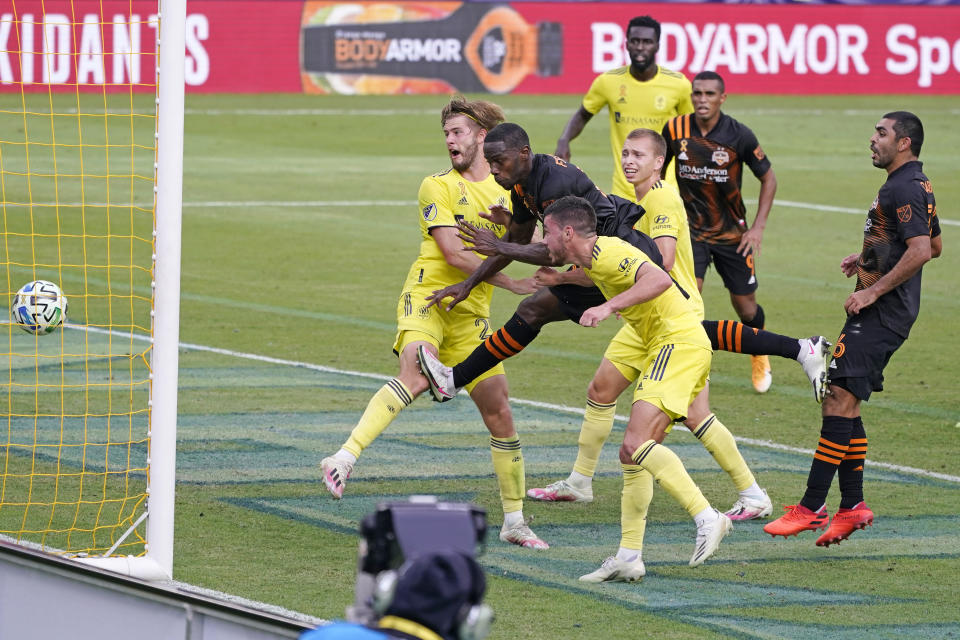 Houston Dynamo defender Maynor Figueroa, second from left, scores a goal from inside a trio of Nashville SC defenders during the second half of an MLS soccer match Saturday, Sept. 26, 2020, in Nashville, Tenn. The game ended in a 1-1 draw. (AP Photo/Mark Humphrey)