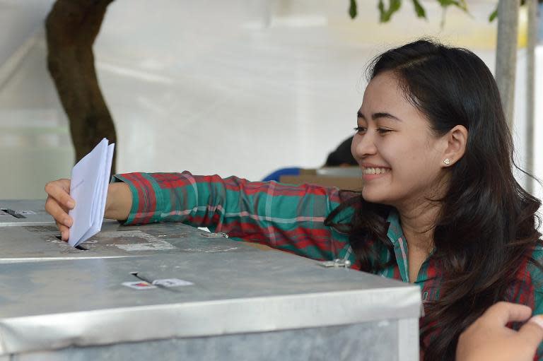 An Indonesian woman casts her ballot at a polling station during legislative elections in Jakarta on April 9, 2014