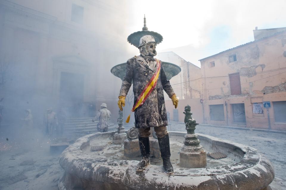 IBI, SPAIN - DECEMBER 28: A Reveller takes part in the battle of 'Enfarinats', a flour fight in celebration of the Els Enfarinats festival on December 28, 2012 in Ibi, Spain. Citizens of Ibi annually celebrate the festival with a battle using flour, eggs and firecrackers. The battle takes place between two groups, a group of married men called 'Els Enfarinats' which take the control of the village for one day pronouncing a whole of ridiculous laws and fining the citizens that infringe them and a group called 'La Oposicio' which try to restore order. At the end of the day the money collected from the fines is donated to charitable causes in the village. The festival has been celebrated since 1981 after the town of Ibi recovered the tradition but the origins remain unknown.Ê (Photo by David Ramos/Getty Images)