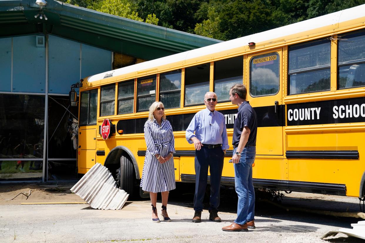 President Biden, First Lady Jill Biden and Kentucky Gov. Andy Beshear, talk while viewing flood damage, Monday, Aug. 8, 2022, in Lost Creek, Ky., where a bus floated into a building.