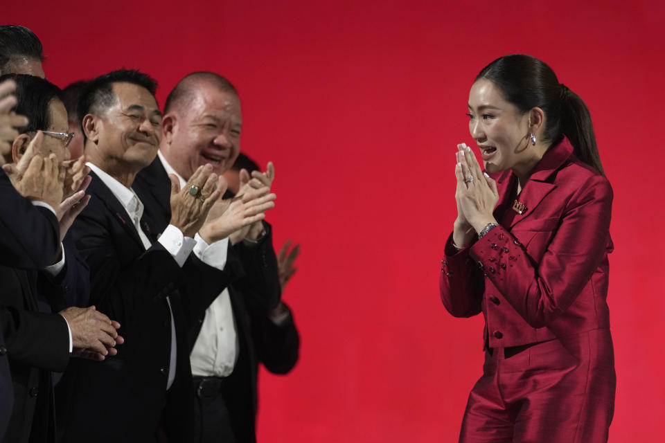 New leader Pheu Thai Party, Paetongtarn Shinawatra, right, daughter of Thailand's former Prime Minister Thaksin Shinawatra, offers a traditional greeting known as a "wai" to member of Pheu Thai Party at the party headquarters in Bangkok, Thailand, Friday, Oct. 27, 2023. Thailand’s ruling party has selected as its leader the daughter of the country’s divisive former prime minister, highlighting her family’s continuing influence more than two decades after her father entered politics. (AP Photo/Sakchai Lalit)