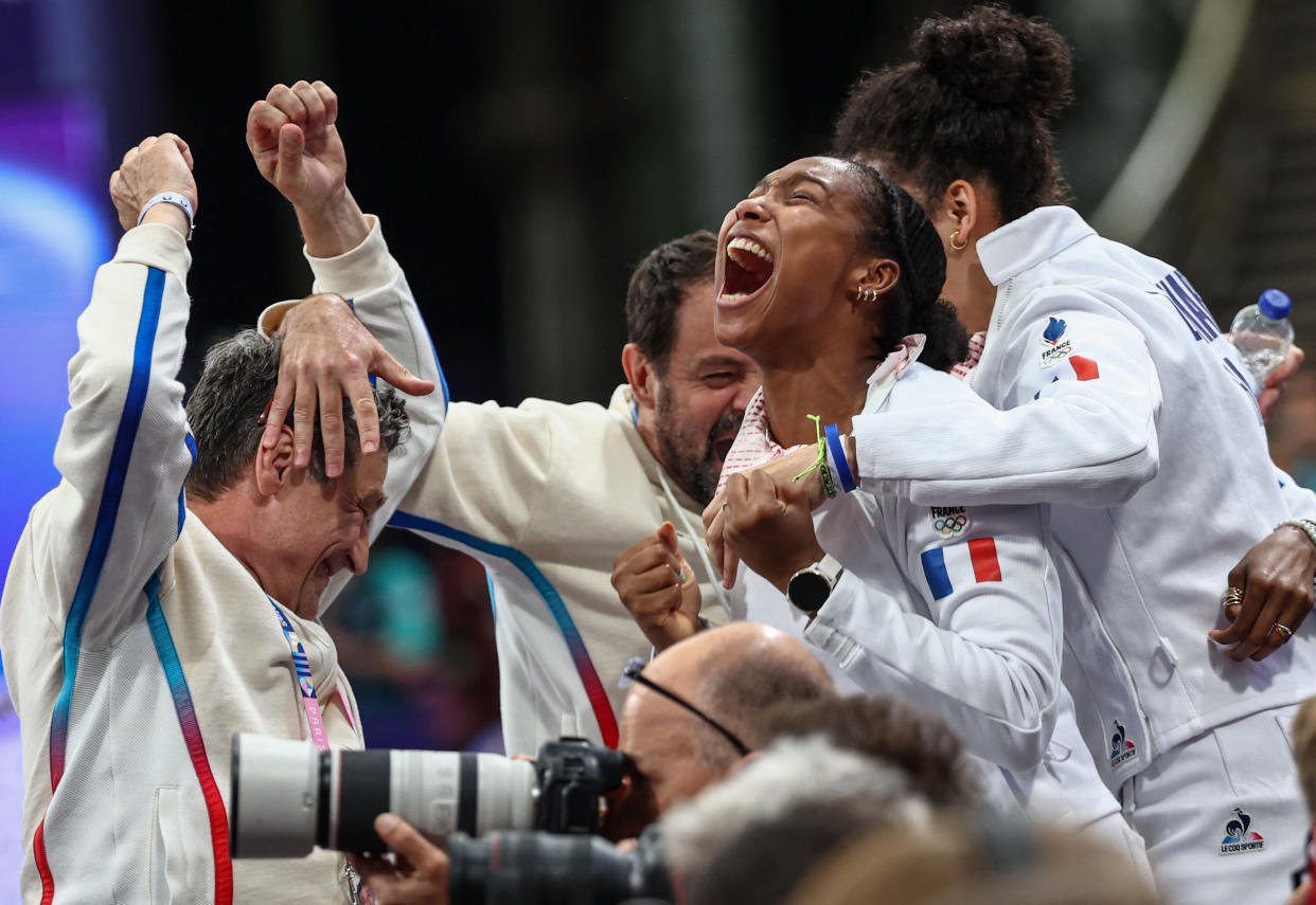 France's team members including France's Coraline Vitalis (2ndL) celebrate after winning in the women's epee team semi-final bout between Poland and France during the Paris 2024 Olympic Games at the Grand Palais in Paris, on July 30, 2024. (Photo by Franck FIFE / AFP)