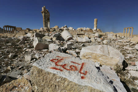 FILE PHOTO: Graffiti sprayed by Islamic State militants which reads "We remain" is seen on a stone at the Temple of Bel in the historic city of Palmyra, in Homs Governorate, Syria April 1, 2016. REUTERS/Omar Sanadik/File Photo