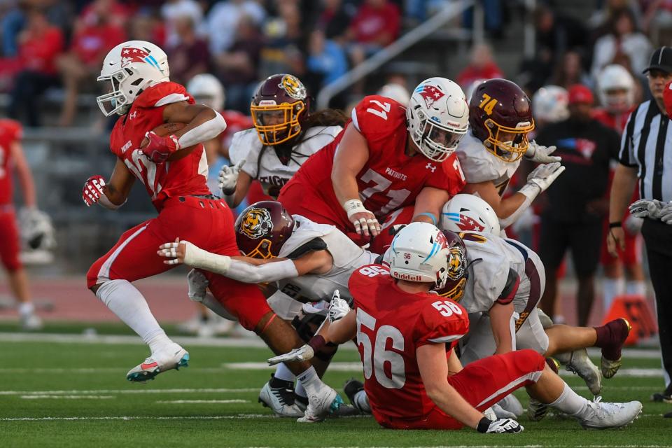 Lincoln’s Dreavin Hodge (22) tries to outrun tackle on Friday, Sept. 15, 2023 at Howard Wood Field in Sioux Falls, South Dakota.