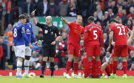 Britain Soccer Football - Liverpool v Everton - Premier League - Anfield - 1/4/17 Everton's Ross Barkley is shown a yellow card by referee Anthony Taylor as Liverpool's Dejan Lovren is on the floor Action Images via Reuters / Carl Recine Livepic