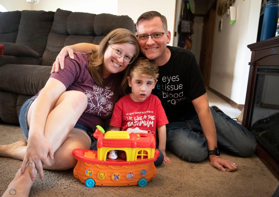 Kaitlyn and Eric Baker, of Independence, Kentucky, with their son James, 4, at home on Aug. 1.