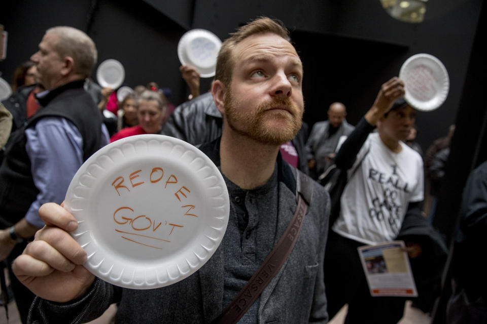 <span class="s1">A furloughed worker protests the partial government shutdown on Jan. 23. Protesters held up disposable plates instead of posters to avoid being arrested. (Photo: Andrew Harnik/AP)</span>