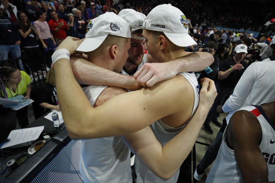 Gonzaga's Martynas Arlauskas, from left, Drew Timme and Filip Petrusev celebrate after defeating Saint Mary's in an NCAA college basketball game in the final of the West Coast Conference men's tournament Tuesday, March 10, 2020, in Las Vegas. (AP Photo/John Locher)