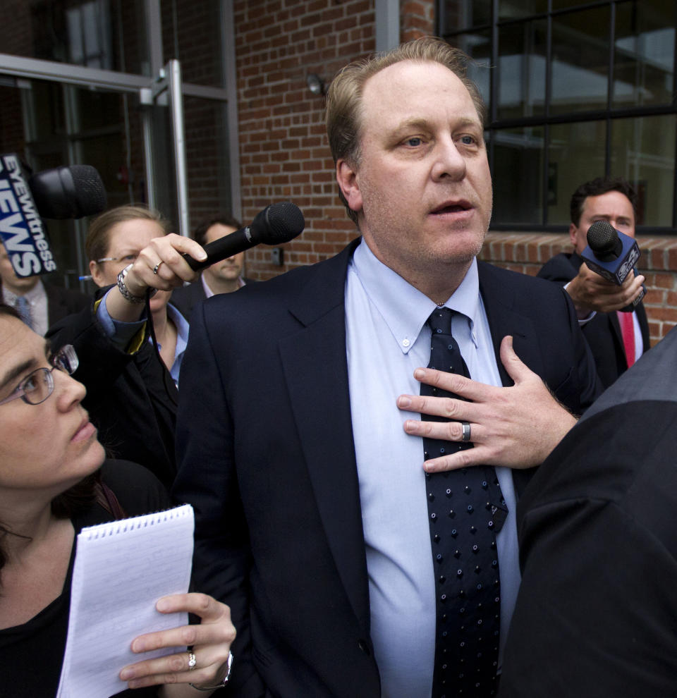 Former Boston Red Sox pitcher Curt Schilling, center, is followed by members of the media as he departs the Rhode Island Economic Development Corporation headquarters, in Providence, R.I., Wednesday, May 16, 2012. Schilling briefed Rhode Island Gov. Lincoln Chafee and economic development officials Wednesday during a closed-door meeting that could determine the fate of his video game company. (AP Photo/Steven Senne)