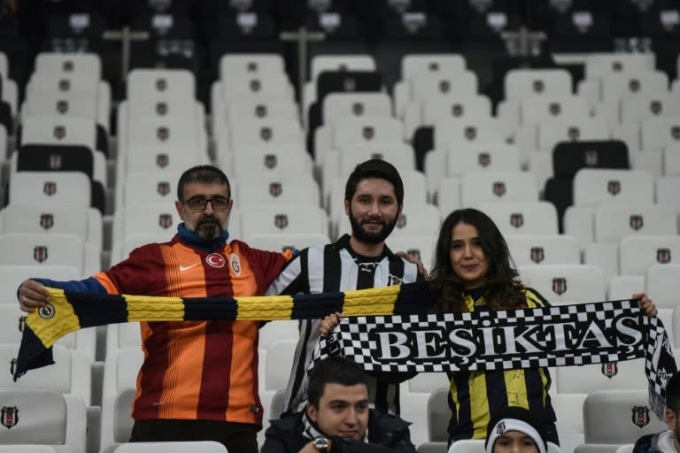 Besiktas, Fenerbahce and Galatasaray's supporters cheer prior to the Ziraat Turkish Cup football match between Besiktas and Kayserispor on December 14, 2016