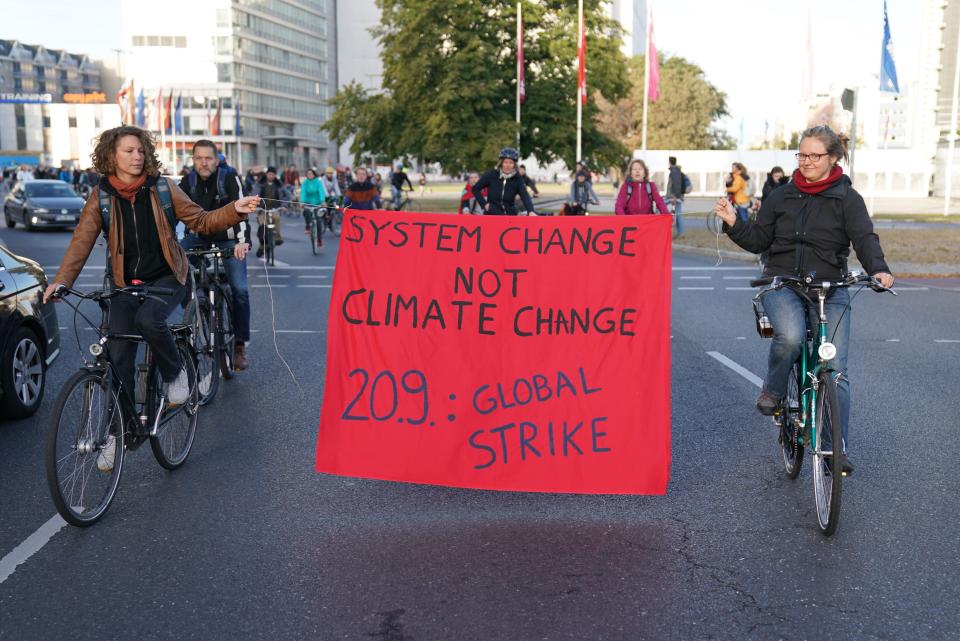 Protesters hold a banner during a bicycle parade in Berlin, Germany, Friday, Sept. 20, 2019 as part of the 'Friday For Future' global strike. Similar rallies are planned Friday in cities around the globe. In the United States more than 800 events were planned Friday, while in Germany more than 400 rallies are expected. (Kay Nietfeld/dpa via AP)