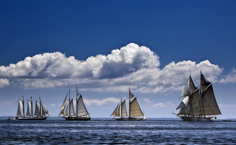 In this photo made July 6, 2012, the schooner Mary Day, right, sails in a schooner race with other members of Maine's windjammer fleet off Rockland, Maine. The 90-foot Mary Day, which is celebrating its 50th season, is the first schooner in the Maine windjammer fleet to be built specifically to accommodate passengers. Its sleeping cabins are heated and have nine feet of headroom. (AP Photo/Robert F. Bukaty)