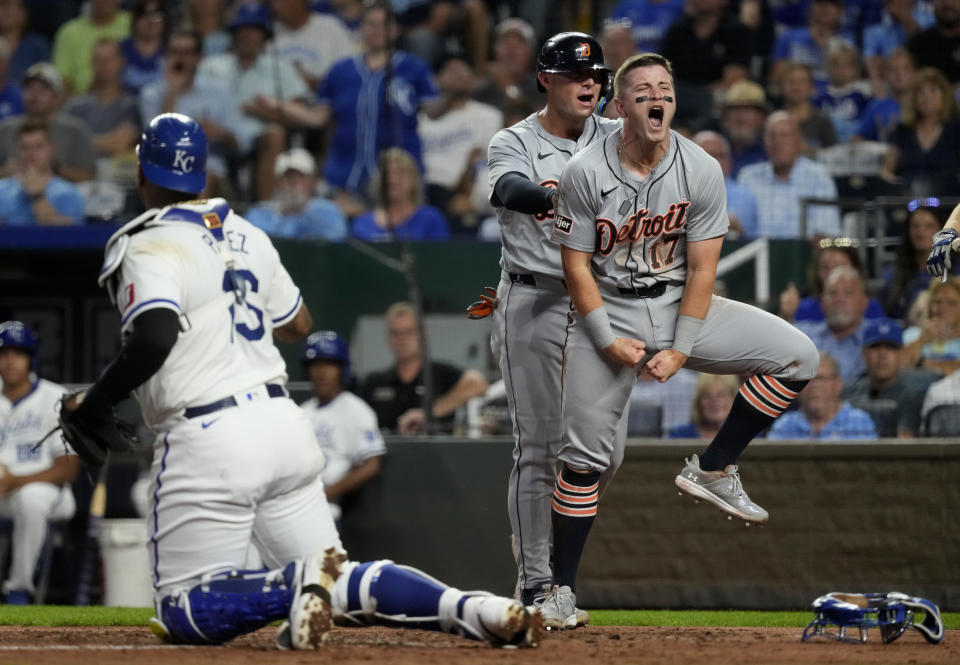 Jace Jung and Spencer Torkelson celebrate after scoring during Wednesday's win. (Ed Zurga/Getty Images)