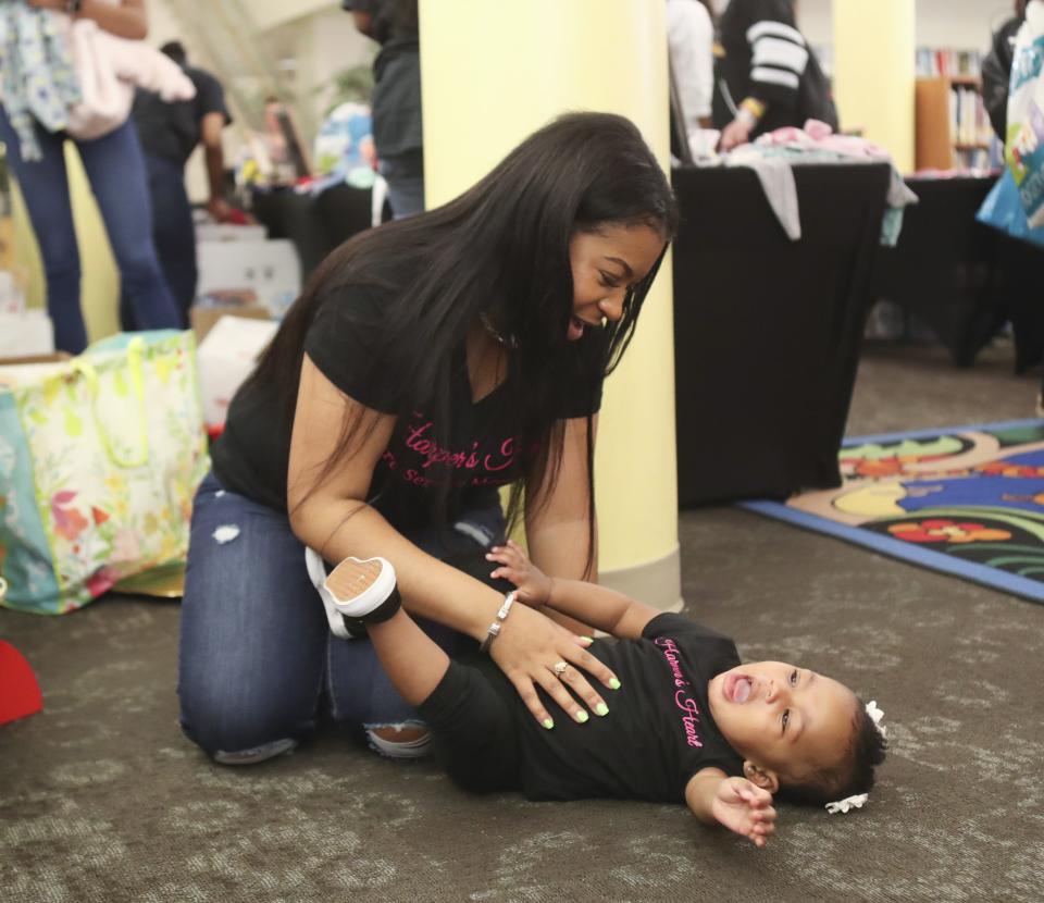 Giovanna Andrews with her daughter Isabella Harper Andrews, the namesake of Harper's Heart, the organization that Andrews started to help expectant or new mothers. She's pictured at the Thousand Bib and Book Giveaway event at the Wilmington Public Library in May 2019.