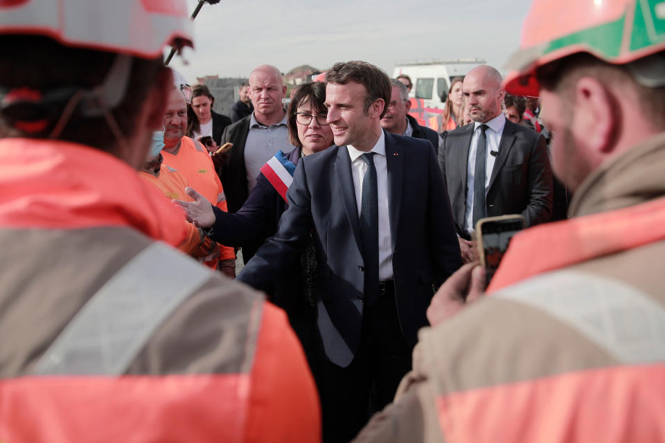 Current French President Emmanuel Macron and local mayor Anne-Lise Dufour-Tonini meet workers as he visits a building site in Denain, northern France, on April 11.<span class="copyright">Lewis Joly—Pool/AP</span>