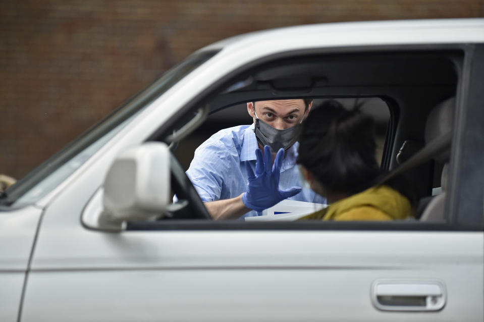 Georgia Democratic candidate for U.S. Senate Jon Ossoff waves after giving a yard sign to a supporter during a drive-through yard sign pick-up event on November 22, 2020. (Photo by Austin McAfee/Icon Sportswire)