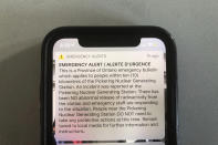 An emergency alert issued by the Canadian province of Ontario reporting an unspecified “incident” at a nuclear plant is shown on a smartphone Sunday, Jan. 12, 2020. Ontario Power Generation later sent a message saying the alert “was sent in error." The initial message said the incident had occurred at the Pickering Nuclear Generating Station, though it added there had been no abnormal release of radioactivity from the station. (AP Photo/Robert Gillies)