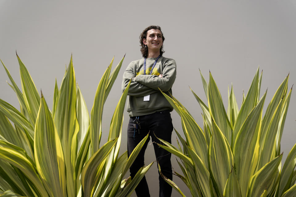 Lucius Giannini stands for a portrait Thursday, April 15, 2021, in San Diego. Giannini graduated from the University of California at San Diego at the end of last summer with a degree in political science. He had hoped to find work with the Peace Corps, or maybe teaching English overseas. But the Peace Corps was bringing all its volunteers home, and no one was hiring for overseas teaching. (AP Photo/Gregory Bull)