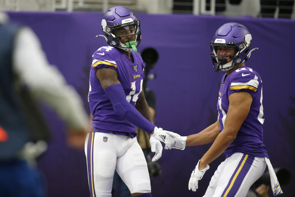 Minnesota Vikings wide receiver Stefon Diggs, left, celebrates with teammate Bisi Johnson, right, after catching a 51-yard touchdown pass during the first half of an NFL football game against the Philadelphia Eagles, Sunday, Oct. 13, 2019, in Minneapolis. (AP Photo/Bruce Kluckhohn)