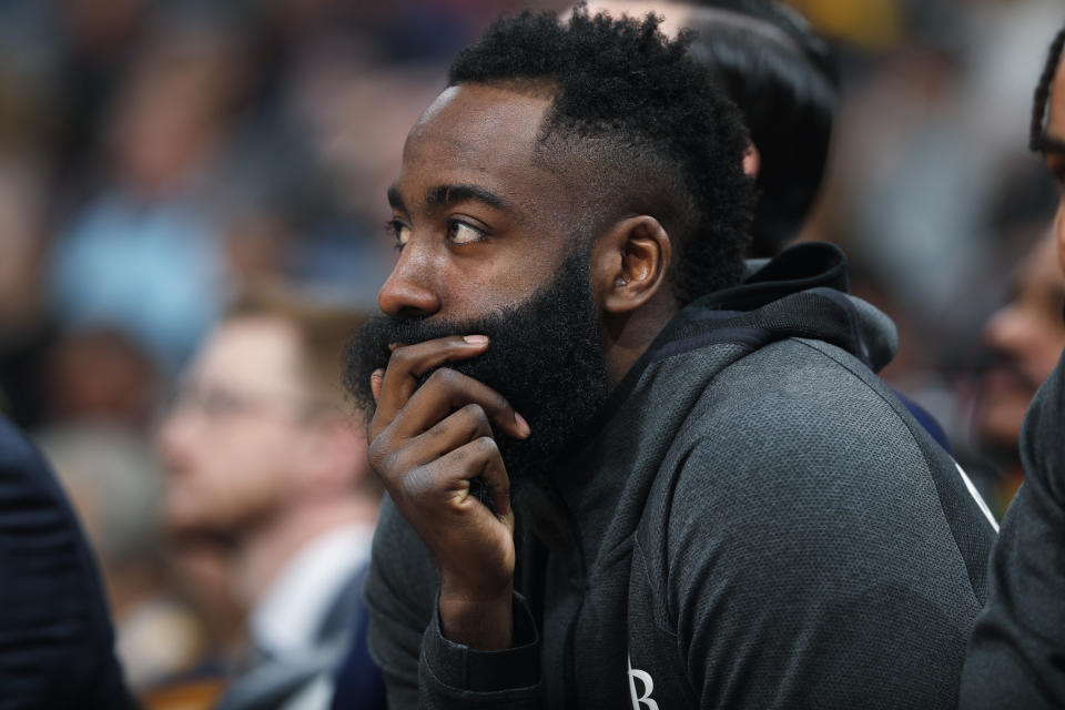 Houston Rockets guard James Harden looks on from the bench in the first half of an NBA basketball game against the Denver Nuggets, Sunday, Jan. 26, 2020, in Denver. (AP Photo/David Zalubowski)