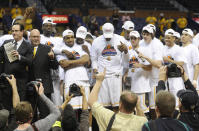 Wichita State coach Gregg Marshall, far left, celebrates with his team after their victory over Indiana State in the an NCAA college basketball game in the championship of the Missouri Valley Conference men's tournament on Sunday, March 9, 2014, in St. Louis. (AP Photo/Bill Boyce)