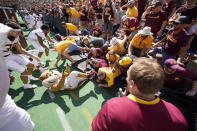 Minnesota fans collapse the fence around the field and trap masoct Goldy the Golden Gopher after an NCAA college football game against Colorado Saturday, Sept. 18, 2021, in Boulder, Colo. Minnesota won 30-0. (AP Photo/David Zalubowski)