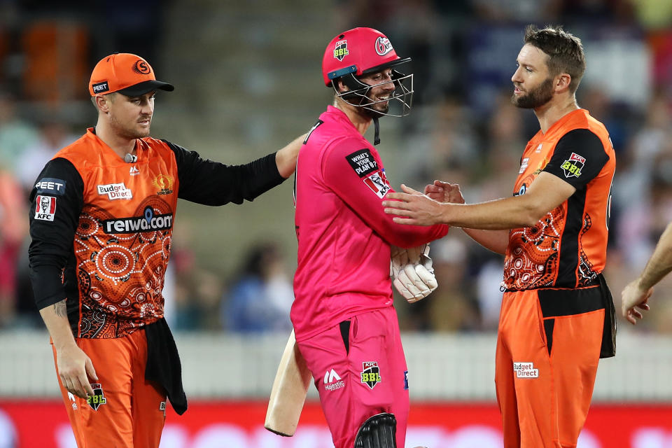 James Vince of the Sixers shows his frustration as he shakes hands with Andrew Tye of the Scorchers after Tye bowled wide that gave the Sixers the win and left Vince not out on 98.